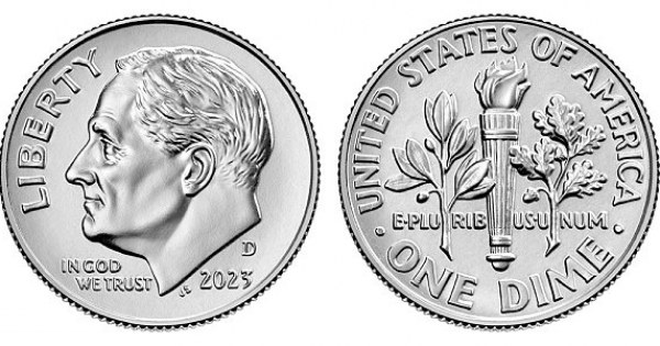 Small silver dime standing upright on clean white surface.